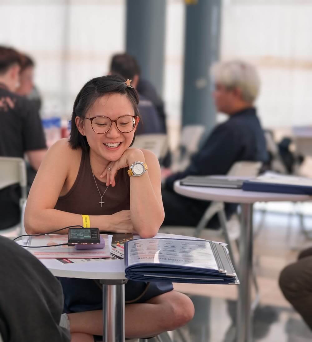 Homeowner smiling while reviewing a design brochure